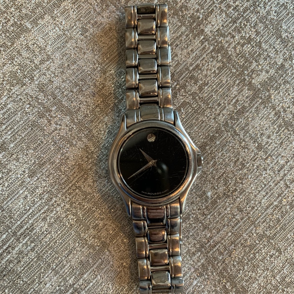 Movado woman’s watch. Black face. Stainless steel